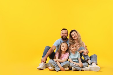 Photo of Happy family on yellow background. Space for text