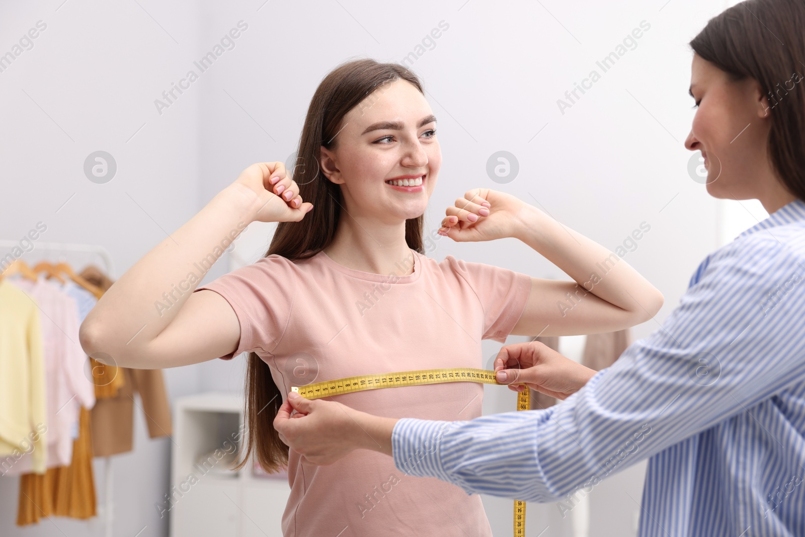 Tailor measuring woman's chest with tape in atelier Photo of Tailor measuring woman's chest with tape in atelier