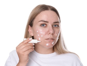 Photo of Woman applying cream onto face on white background. Acne treatment