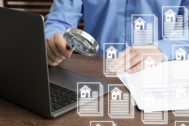 Image of Real estate agent with magnifying glass using laptop at table, closeup. Database on virtual screen