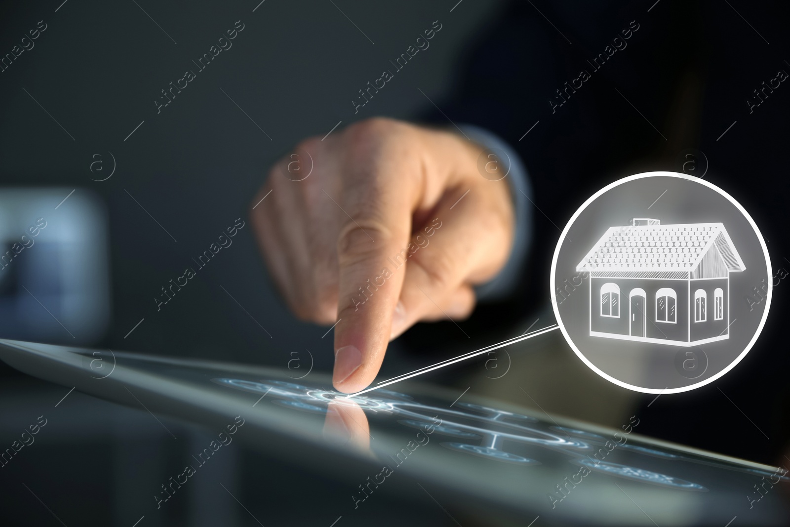 Real estate agent using tablet computer, closeup. House icon on virtual screen Image of Real estate agent using tablet computer, closeup. House icon on virtual screen