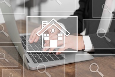 Image of Real estate agent using laptop at table, closeup. House and magnifying glass icons on virtual screen