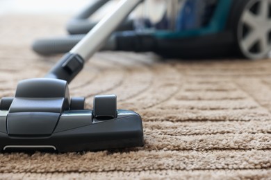 Photo of One vacuum cleaner on floor indoors, closeup