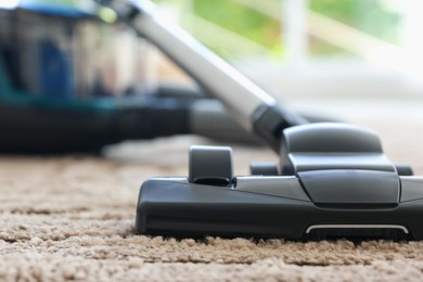 Photo of One vacuum cleaner on floor indoors, closeup