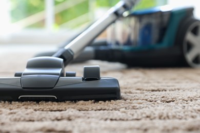 Photo of One vacuum cleaner on floor indoors, closeup