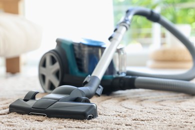 Photo of One vacuum cleaner on floor indoors, closeup