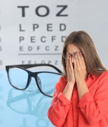 Image of Woman with eyesight problems, glasses and vision test chart