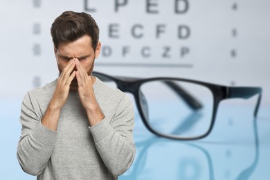 Image of Man with eyesight problems, glasses and vision test chart