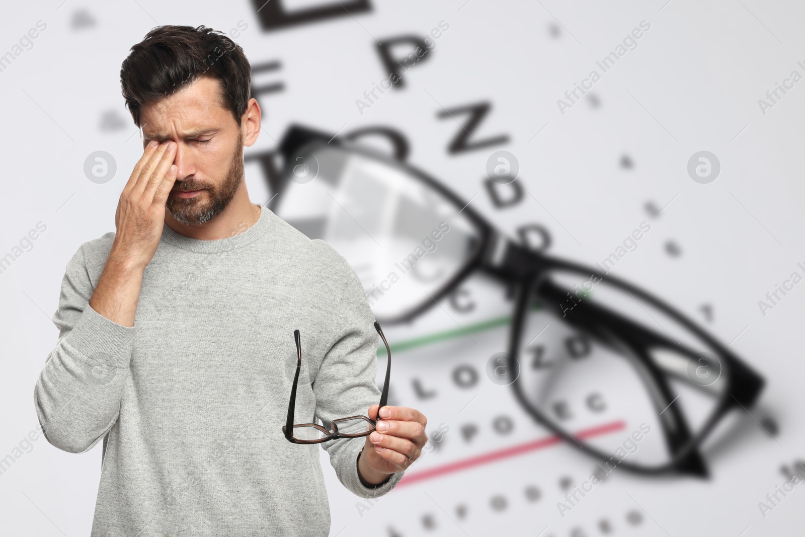 Man with eyesight problems, glasses and vision test chart Image of Man with eyesight problems, glasses and vision test chart