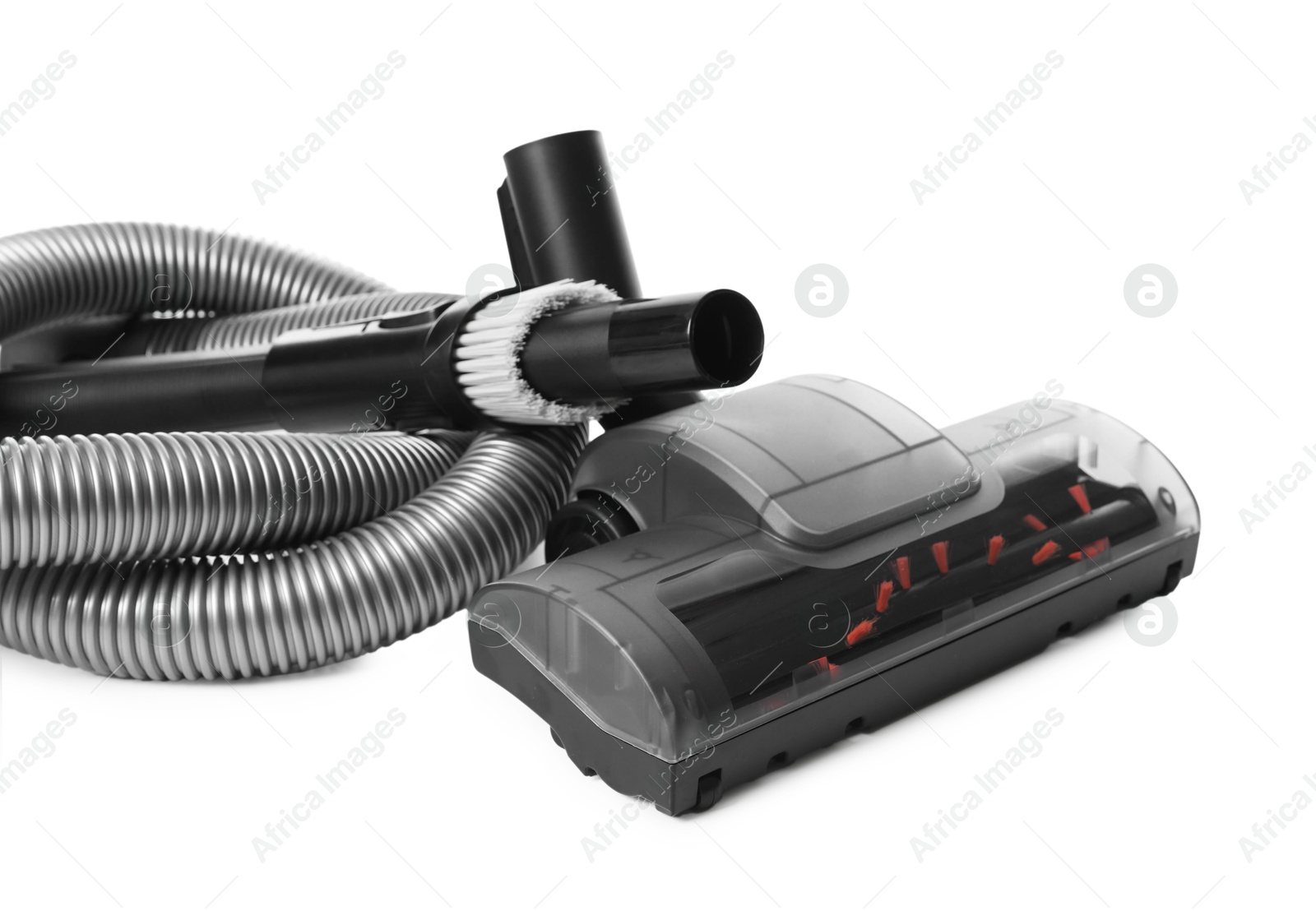 Vacuum cleaner brushes and hose on white background Photo of Vacuum cleaner brushes and hose on white background