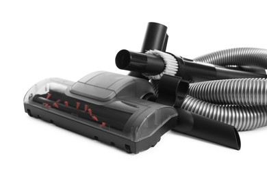 Photo of Vacuum cleaner brushes and hose on white background