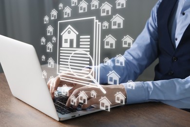 Image of Real estate agent using laptop at table, closeup. House and magnifying glass icons on virtual screen
