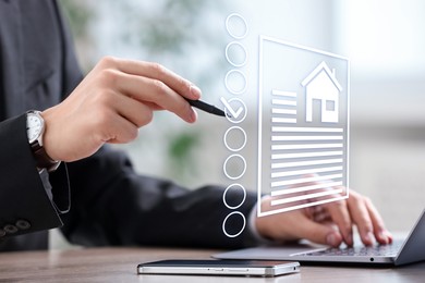 Image of Real estate agent putting tick into checklist near house data on virtual screen at table, closeup
