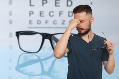 Image of Man with eyesight problems, glasses and vision test chart