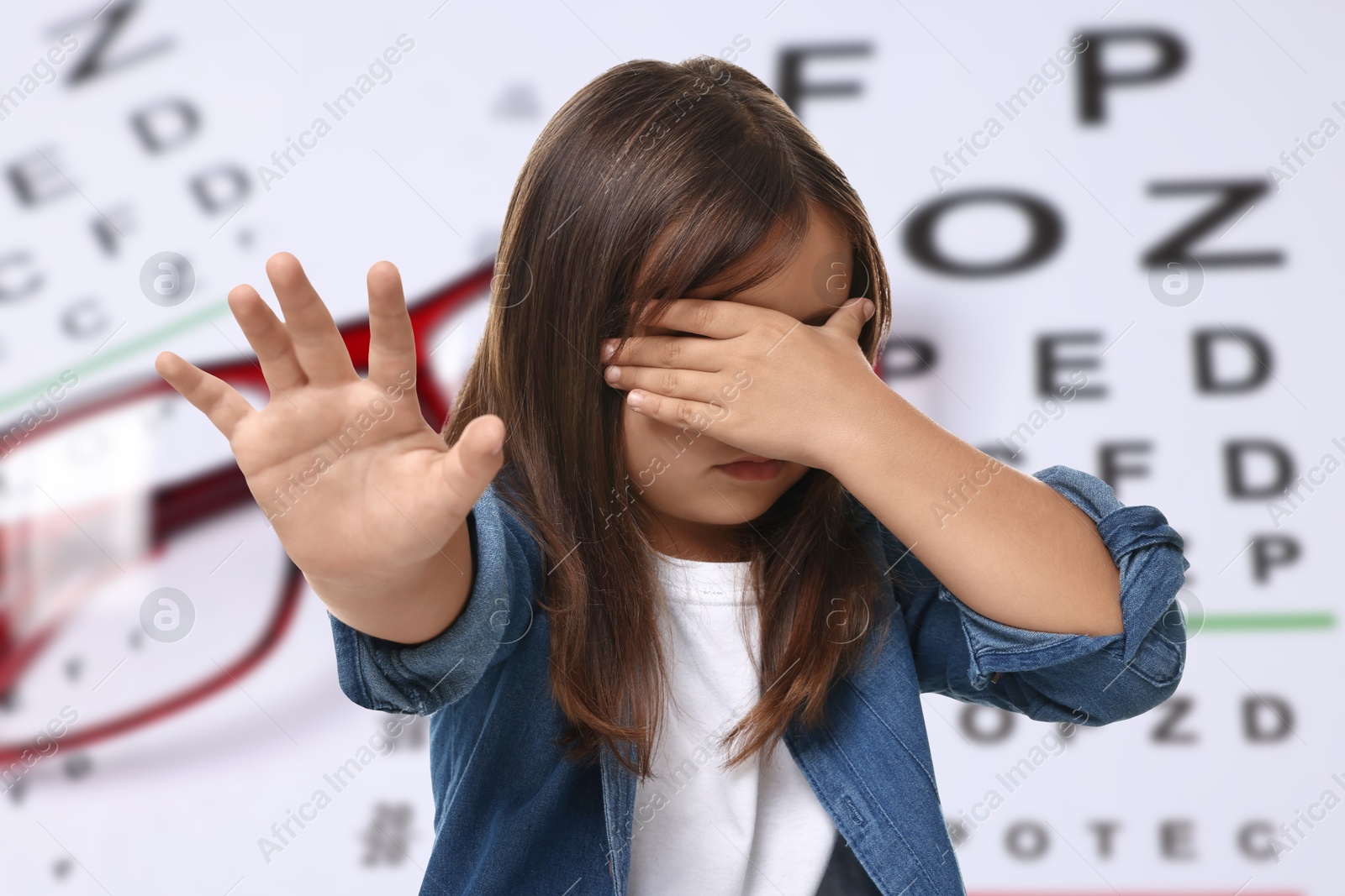 Little girl with eyesight problems, glasses and vision test chart Image of Little girl with eyesight problems, glasses and vision test chart