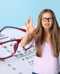Image of Woman with eyesight problems, glasses and vision test chart on light blue background