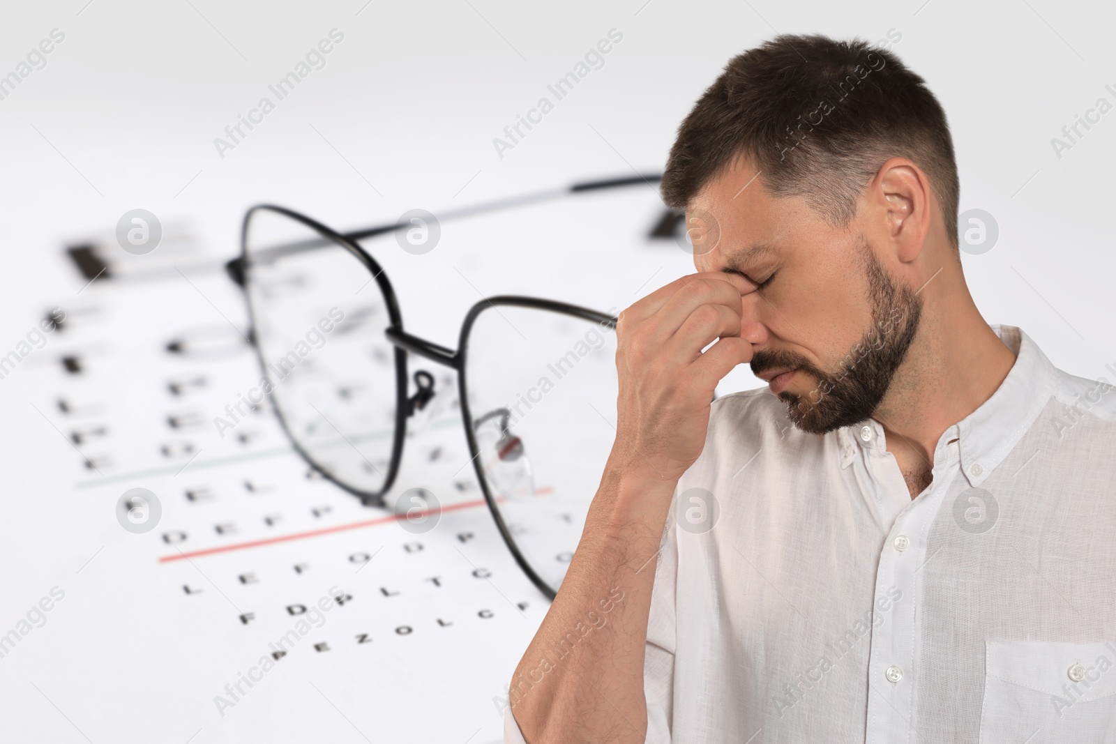 Man with eyesight problems, glasses and vision test chart Image of Man with eyesight problems, glasses and vision test chart
