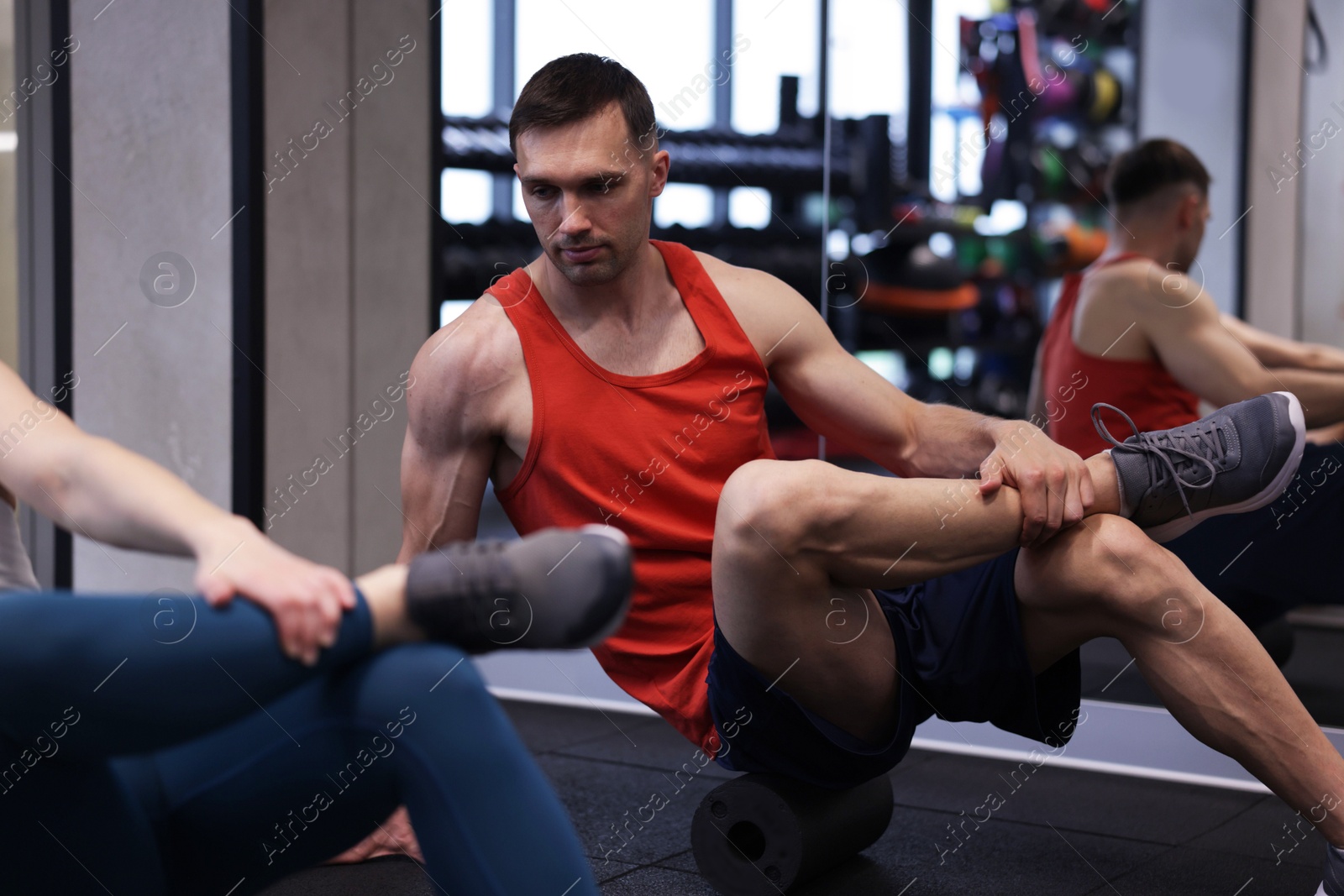 Young woman exercising with professional personal trainer in gym, closeup Photo of Young woman exercising with professional personal trainer in gym, closeup