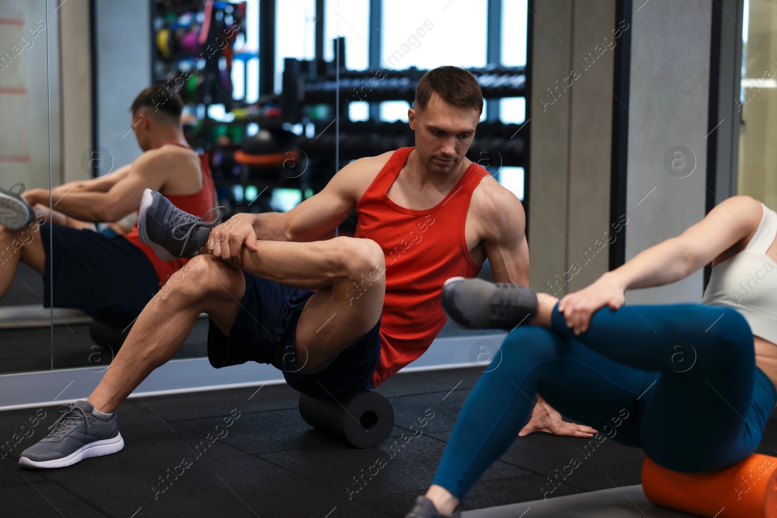 Young woman exercising on fitness mat with professional personal trainer in gym, closeup Photo of Young woman exercising on fitness mat with professional personal trainer in gym, closeup