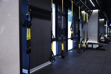 Photo of Professional suspension trainers in modern gym. Healthy lifestyle