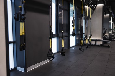 Photo of Professional suspension trainers in modern gym. Healthy lifestyle