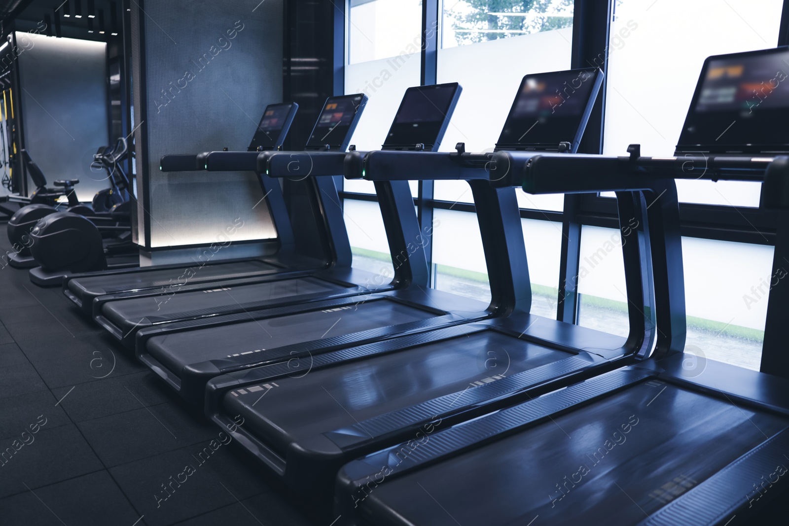 Many modern professional treadmills in gym. Healthy lifestyle Photo of Many modern professional treadmills in gym. Healthy lifestyle