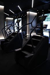 Photo of Professional stair climber machines in gym. Healthy lifestyle