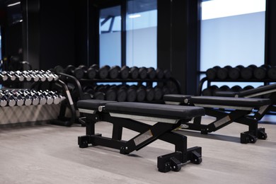 Photo of Dumbbells and other equipment in professional gym