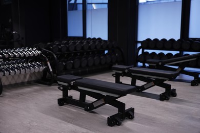Photo of Dumbbells and other equipment in professional gym