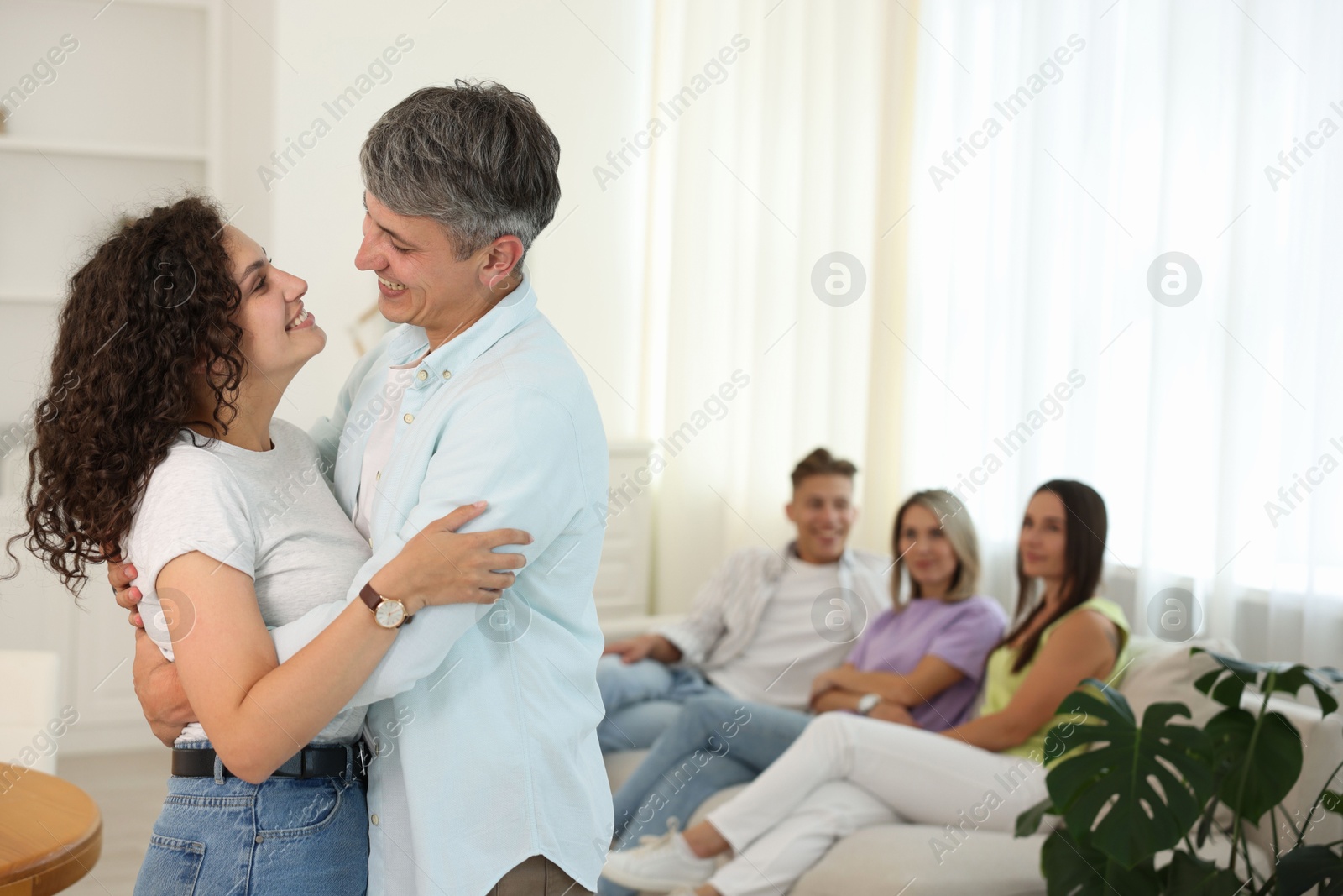 Happy friends hugging at home, selective focus Photo of Happy friends hugging at home, selective focus