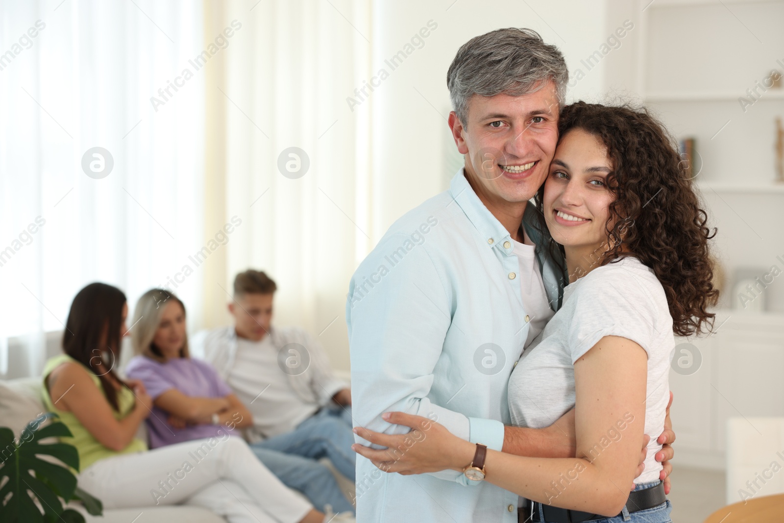 Happy friends hugging at home, selective focus Photo of Happy friends hugging at home, selective focus