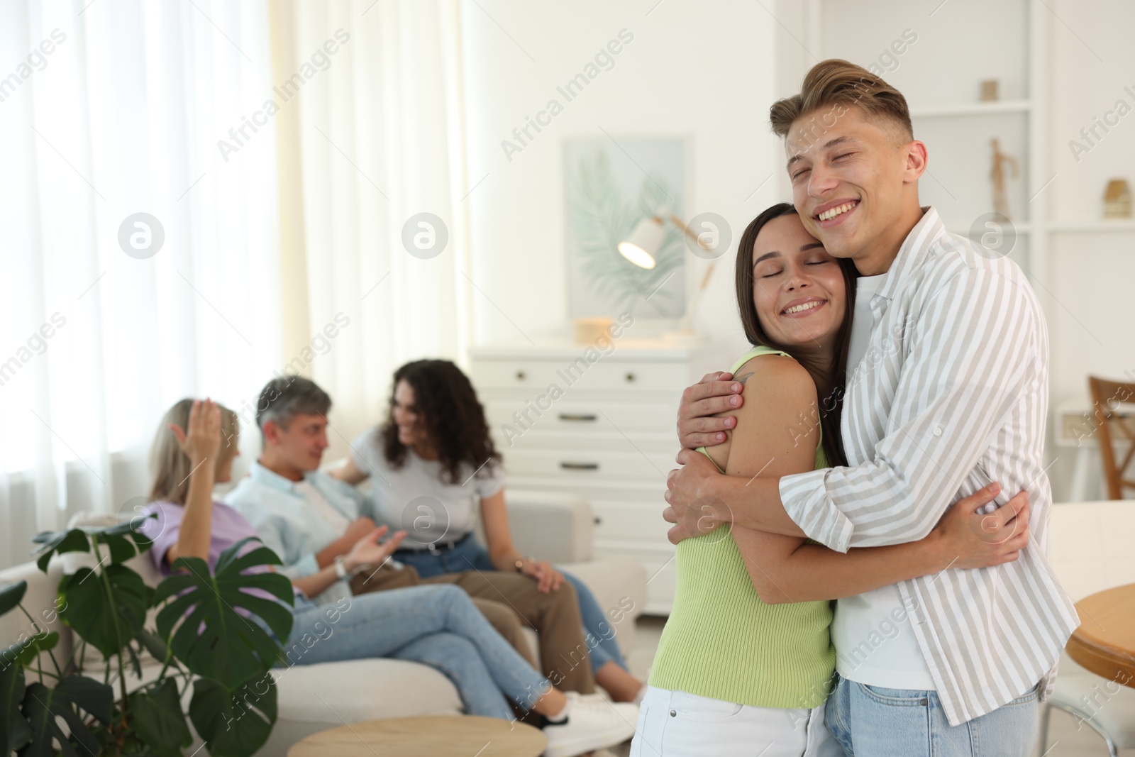Happy friends hugging at home, selective focus Photo of Happy friends hugging at home, selective focus