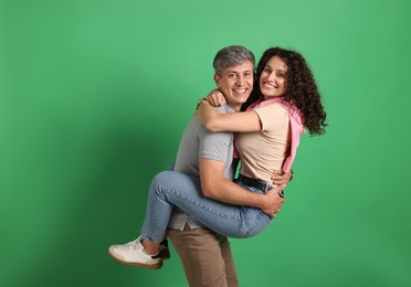 Photo of Happy friends hugging each other on green background
