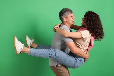 Photo of Happy friends hugging each other on green background