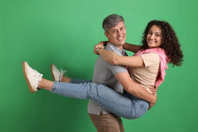 Photo of Happy friends hugging each other on green background
