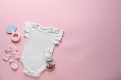 Photo of Baby clothes and accessories on pink background, flat lay. Space for text