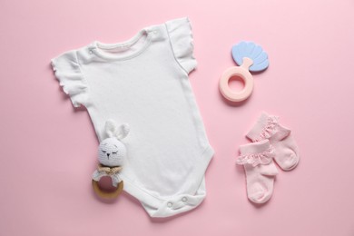 Photo of Baby clothes and accessories on pink background, flat lay