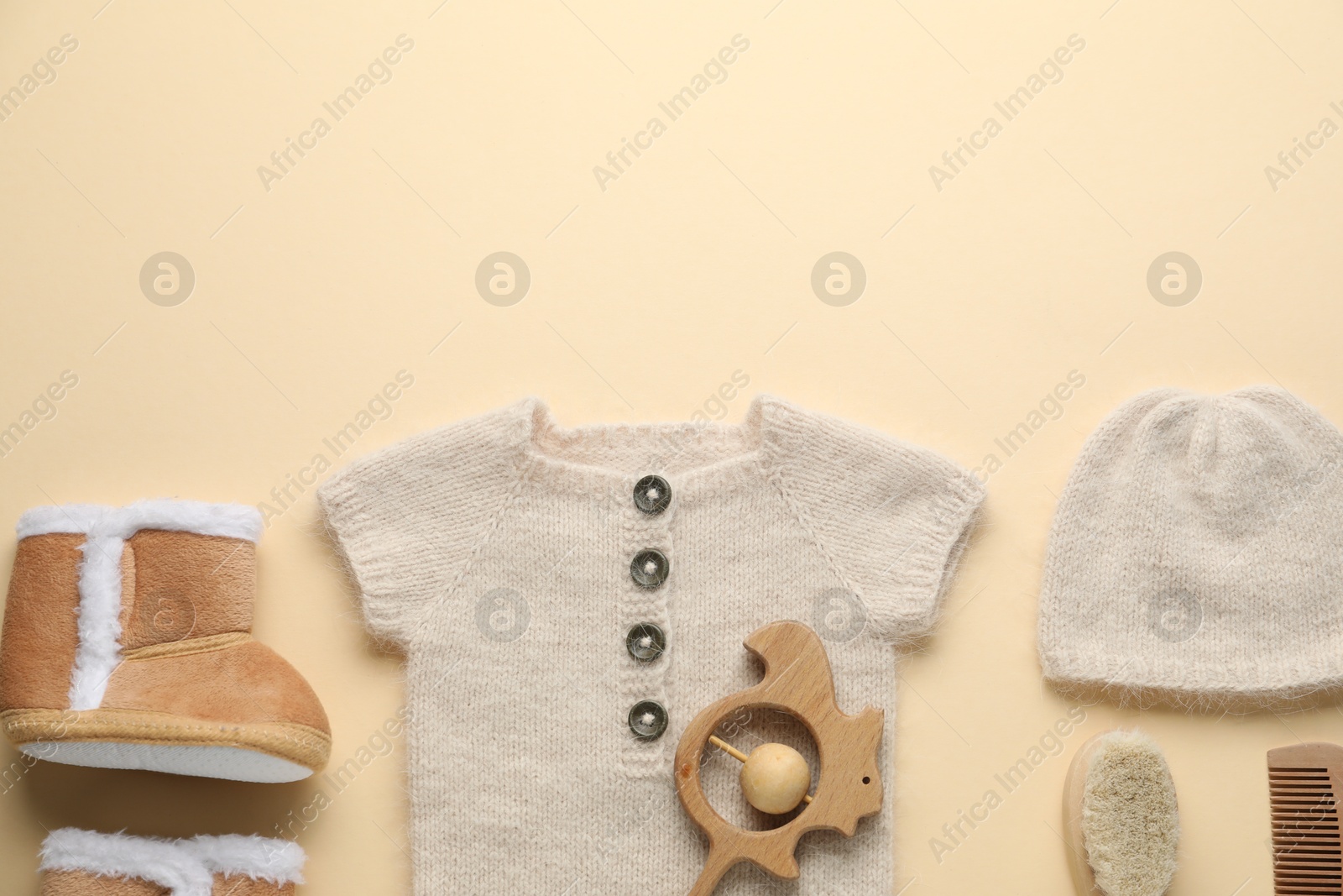 Baby clothes and accessories on beige background, flat lay. Space for text Photo of Baby clothes and accessories on beige background, flat lay. Space for text