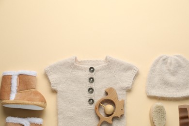 Photo of Baby clothes and accessories on beige background, flat lay. Space for text