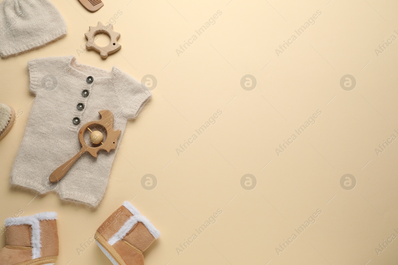 Photo of Baby clothes and accessories on beige background, flat lay. Space for text
