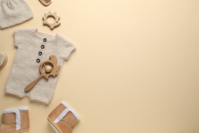 Photo of Baby clothes and accessories on beige background, flat lay. Space for text