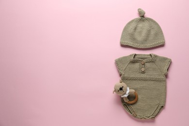 Photo of Baby clothes and accessory on pink background, flat lay. Space for text