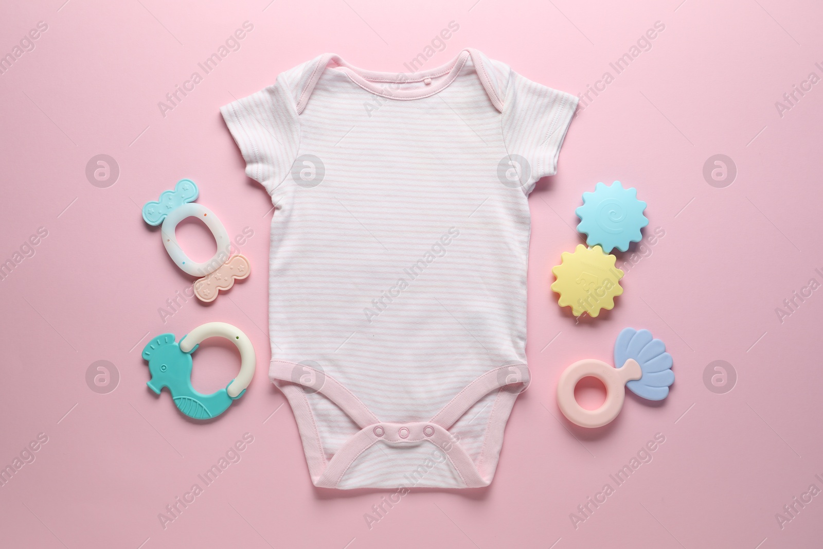 Baby onesie and accessories on pink background, flat lay Photo of Baby onesie and accessories on pink background, flat lay