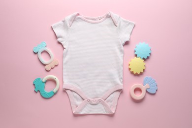 Photo of Baby onesie and accessories on pink background, flat lay