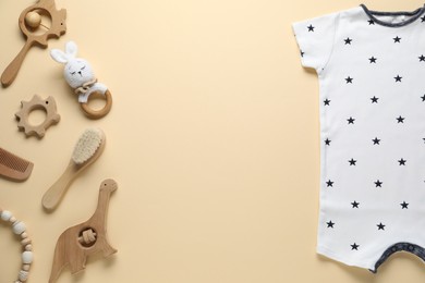 Photo of Baby romper and accessories on beige background, flat lay. Space for text