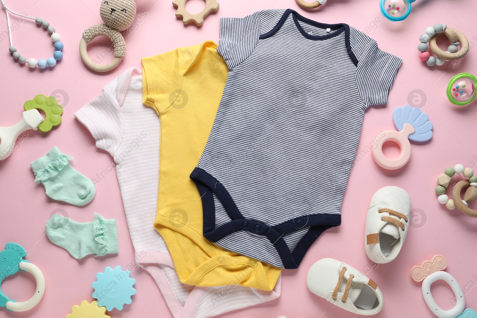 Photo of Baby clothes and accessories on pink background, flat lay