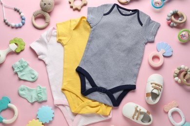 Photo of Baby clothes and accessories on pink background, flat lay