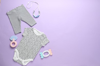 Photo of Baby clothes and accessories on violet background, flat lay. Space for text