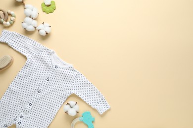 Photo of Baby romper and accessories on beige background, flat lay. Space for text