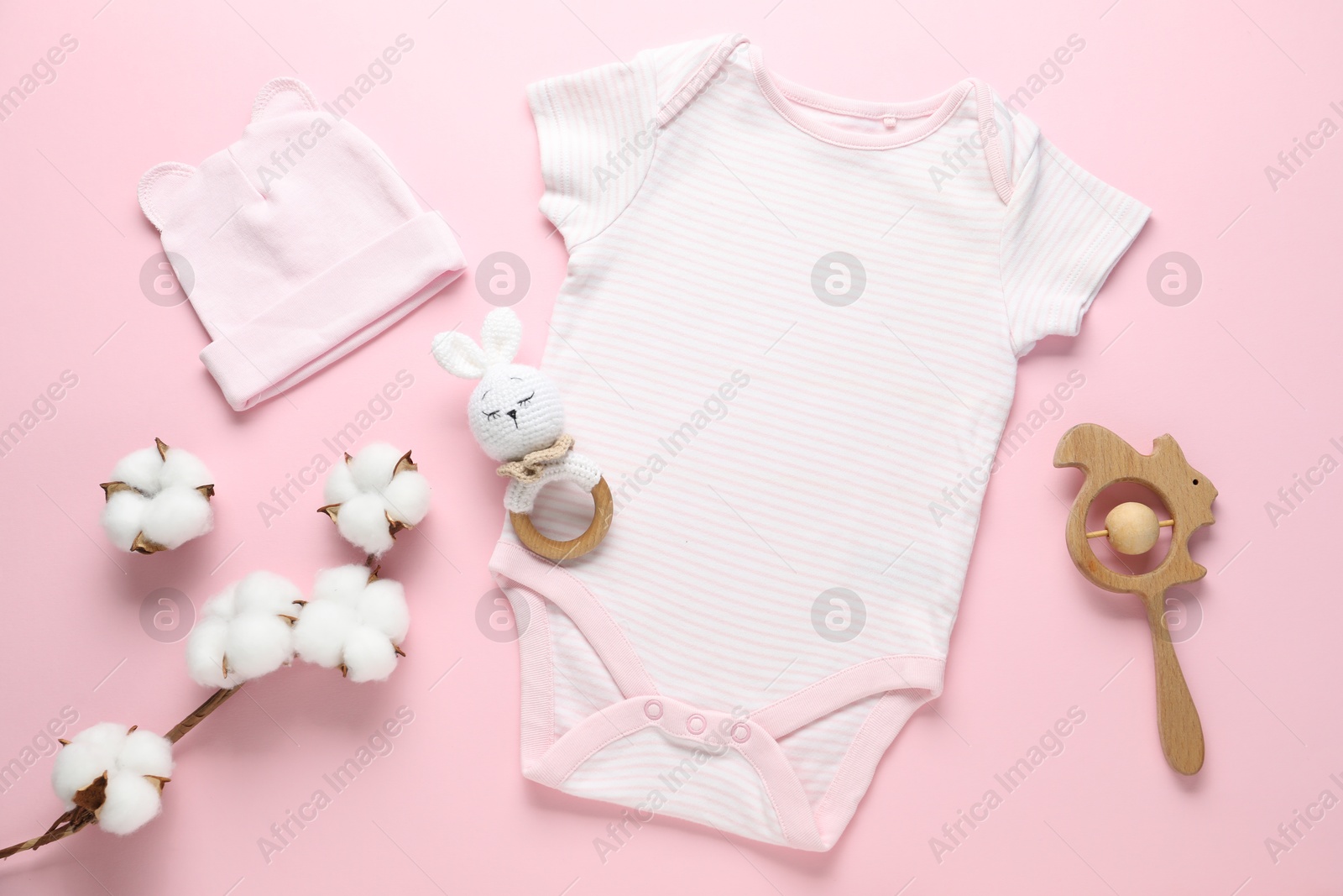 Baby clothes, cotton flowers and accessories on pink background, flat lay Photo of Baby clothes, cotton flowers and accessories on pink background, flat lay